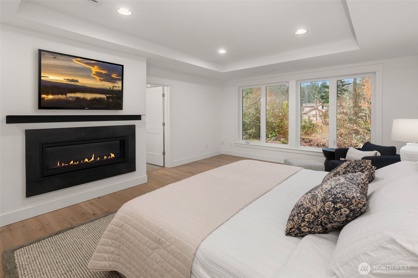 21021 Southeast 80th Street Issaquah, WA 98027 - Photo 28 of 38 a bedroom with a bed and a fireplace