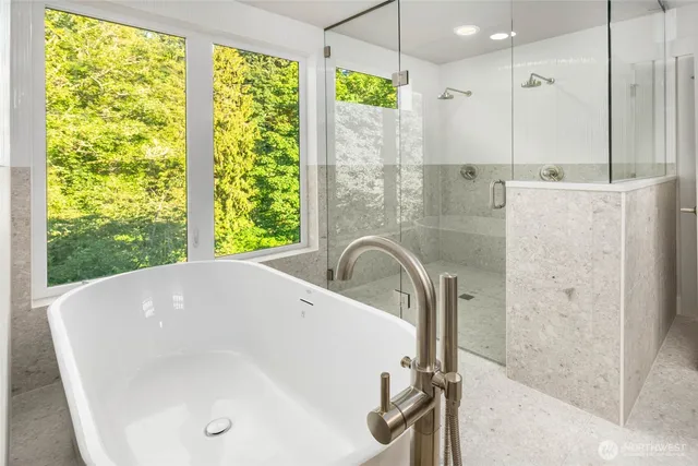 a bathroom with a double vanity sink mirror and bathtub