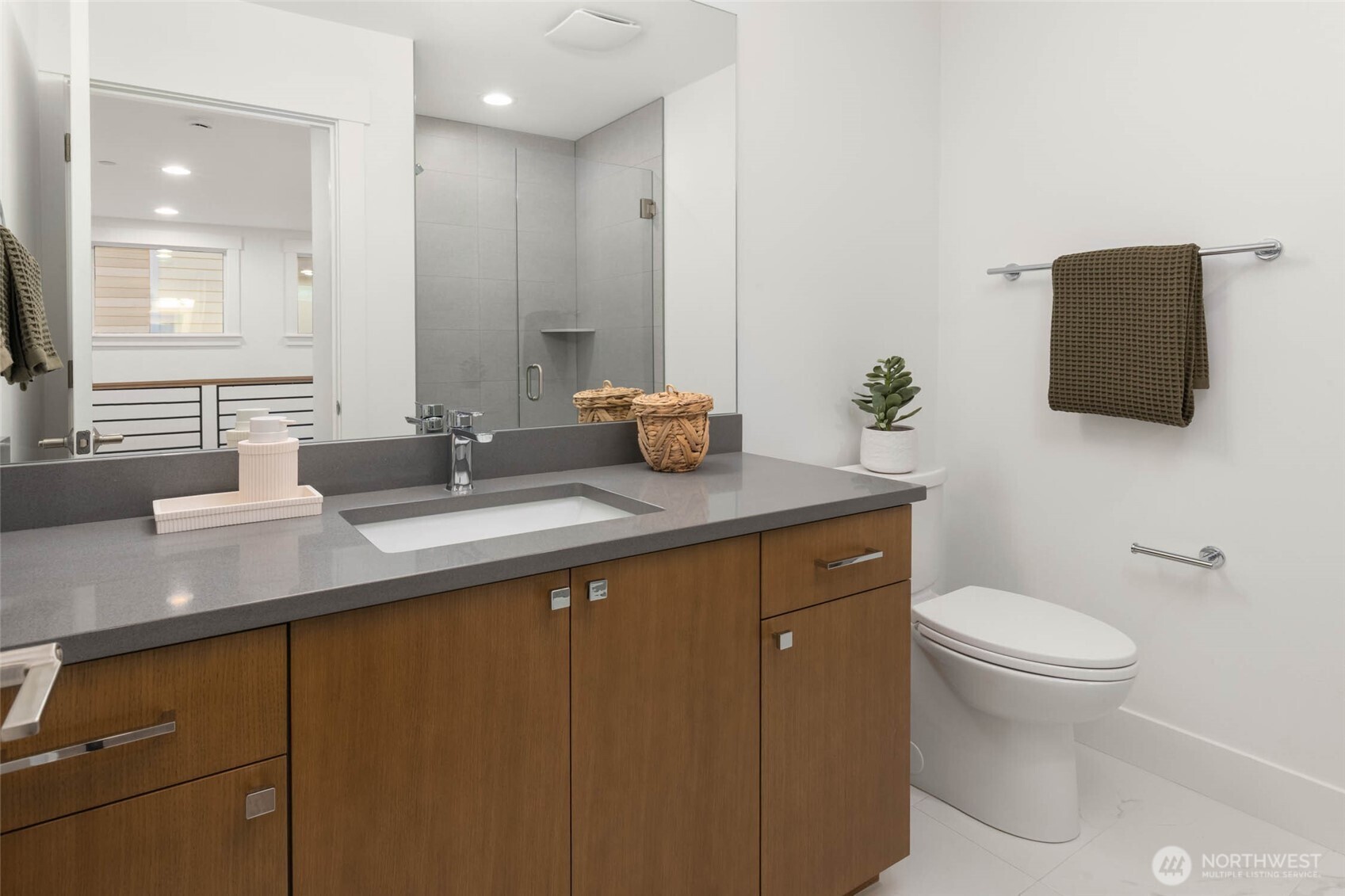 21021 Southeast 80th Street Issaquah, WA 98027 - Photo 34 of 38 a bathroom with a granite countertop sink a large mirror and toilet
