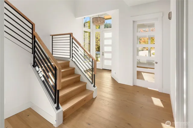 a view of entryway and hall with wooden floor