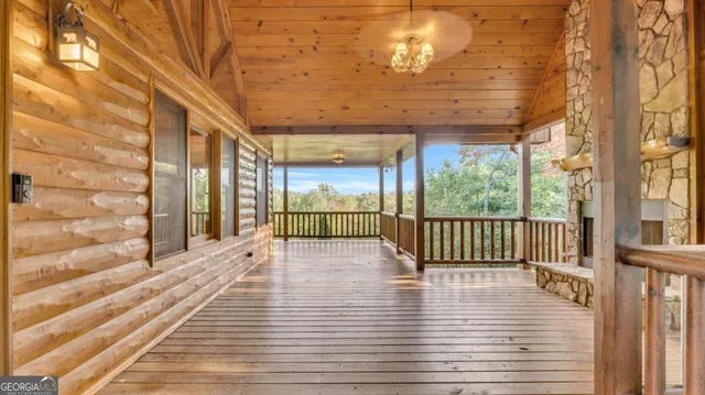 a view of backyard with a deck and wooden floor