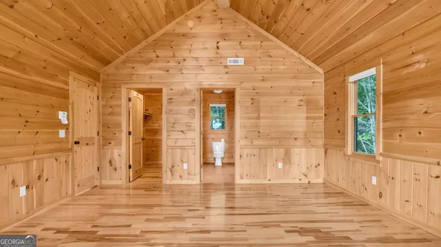 a view of a white house with a yard and plants