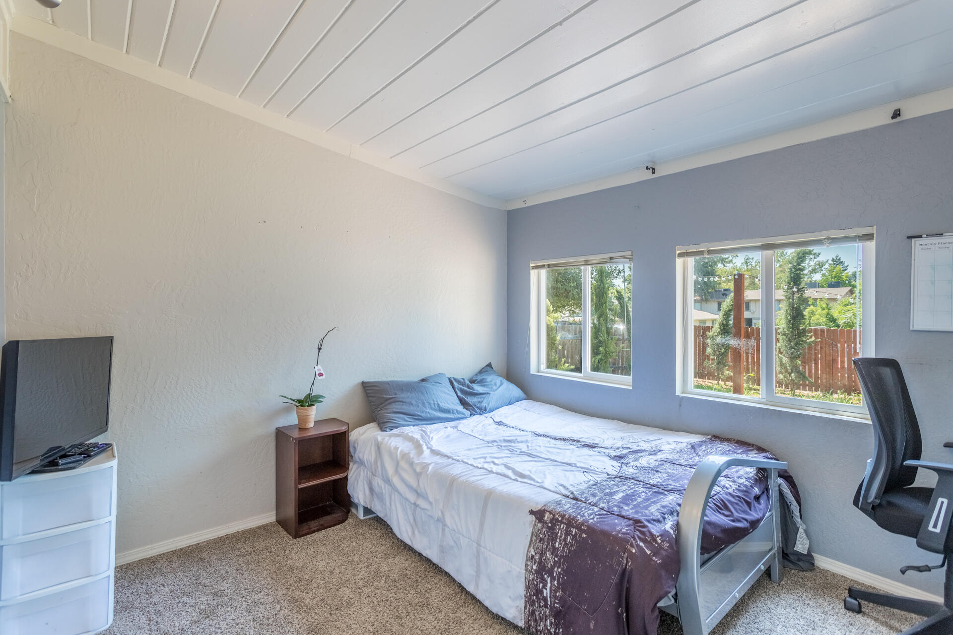 1116 Layton Road Redding, CA 96002 - Photo 7 of 11 a bedroom with a bed and large windows