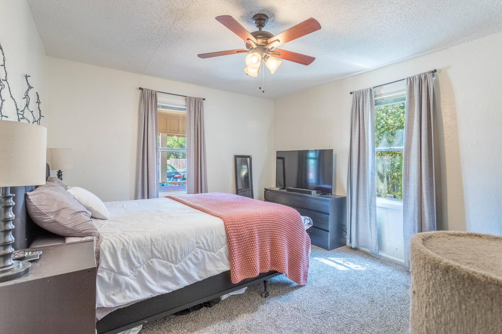 1116 Layton Road Redding, CA 96002 - Photo 8 of 11 a bedroom with a bed and a chandelier