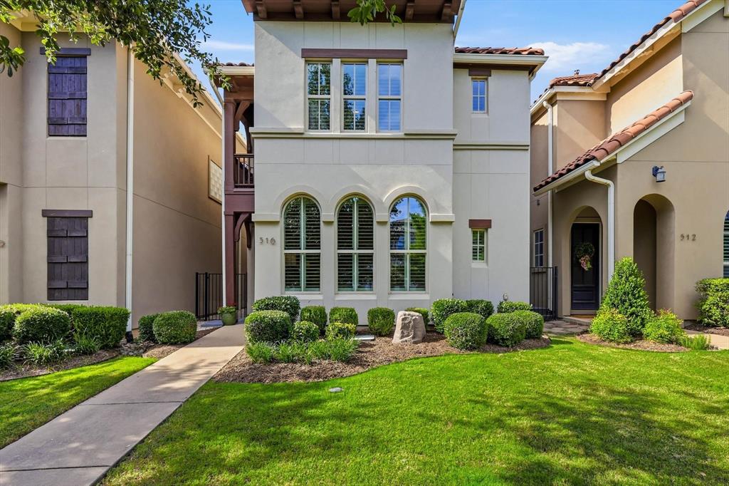 516 Sandy Lane Flower Mound, TX 75022 - Photo 1 of 38 Stucco exterior featuring arched windows, dark wood shutters, and a terracotta tile roof