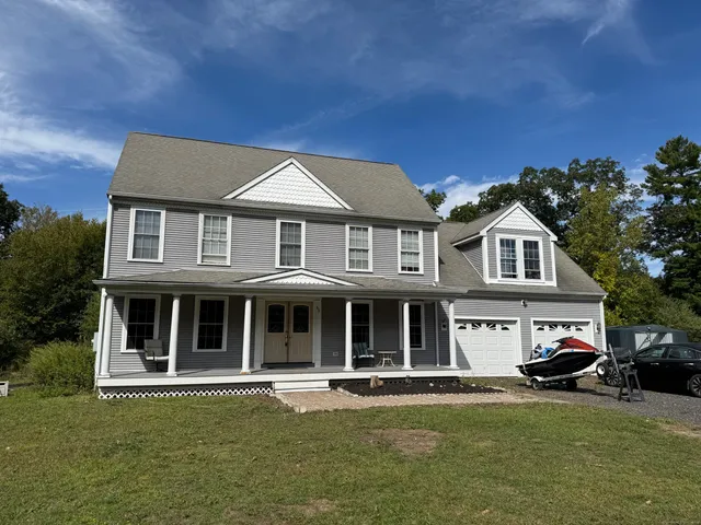 a front view of a residential apartment building with a yard