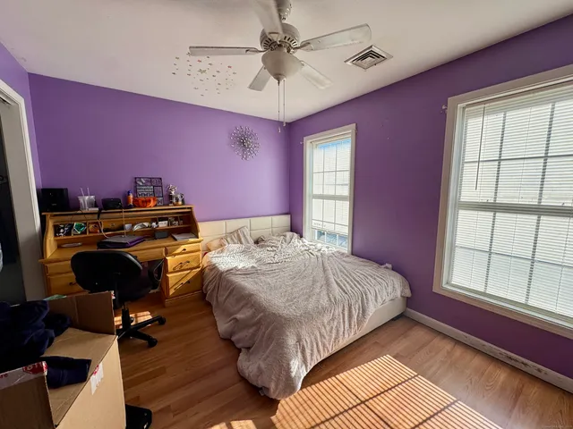 a bedroom with a bed and a window