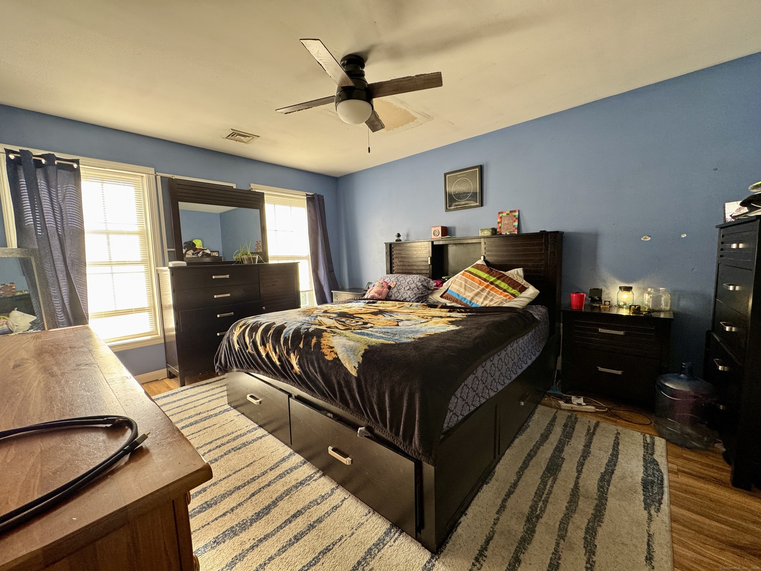 85 Soap Street Killingly, CT 06241 - Photo 12 of 13 a bedroom with a bed and wooden floor