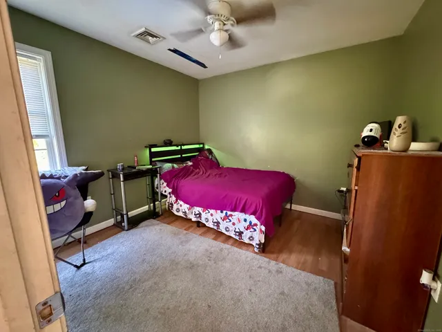 a bedroom with a bed and a table in it