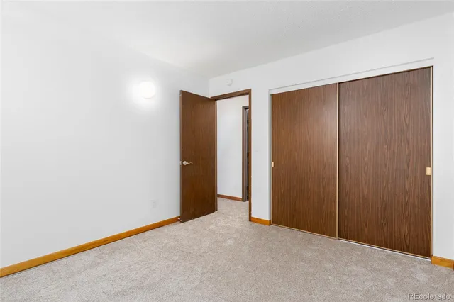 an empty room with closet area