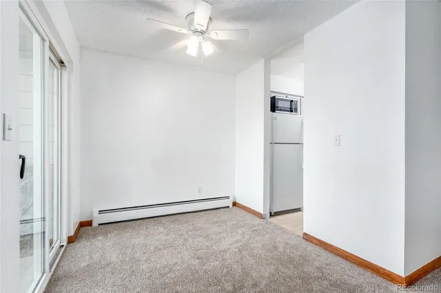 an empty room with closet and windows