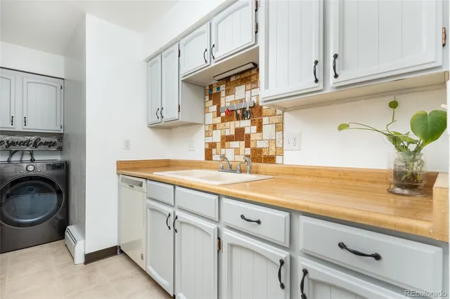 a kitchen with appliances cabinets and a sink