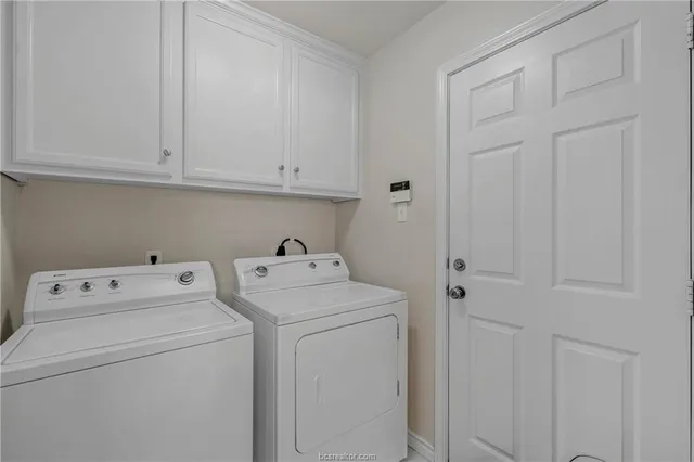 a view of storage and utility room with washer and dryer