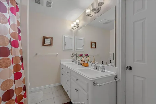 a bathroom with a sink vanity and a mirror