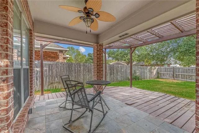 a view of a patio with a table chairs and a backyard