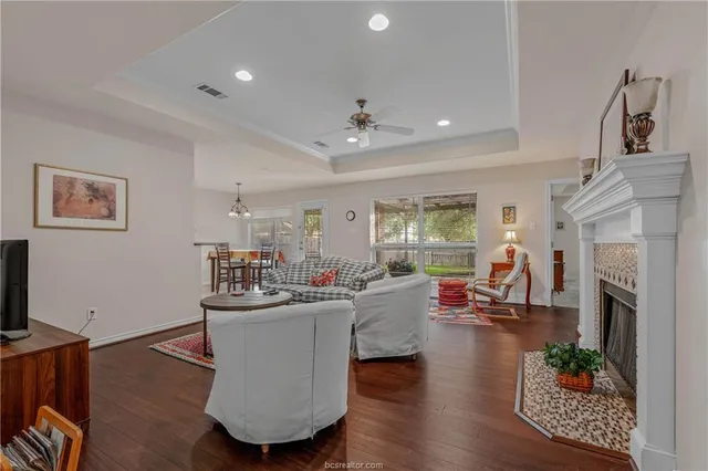 a living room with furniture a fireplace and a flat screen tv