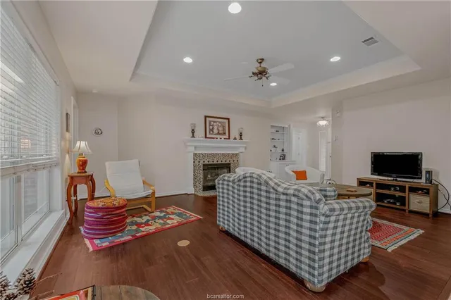 a living room with furniture fireplace and flat screen tv