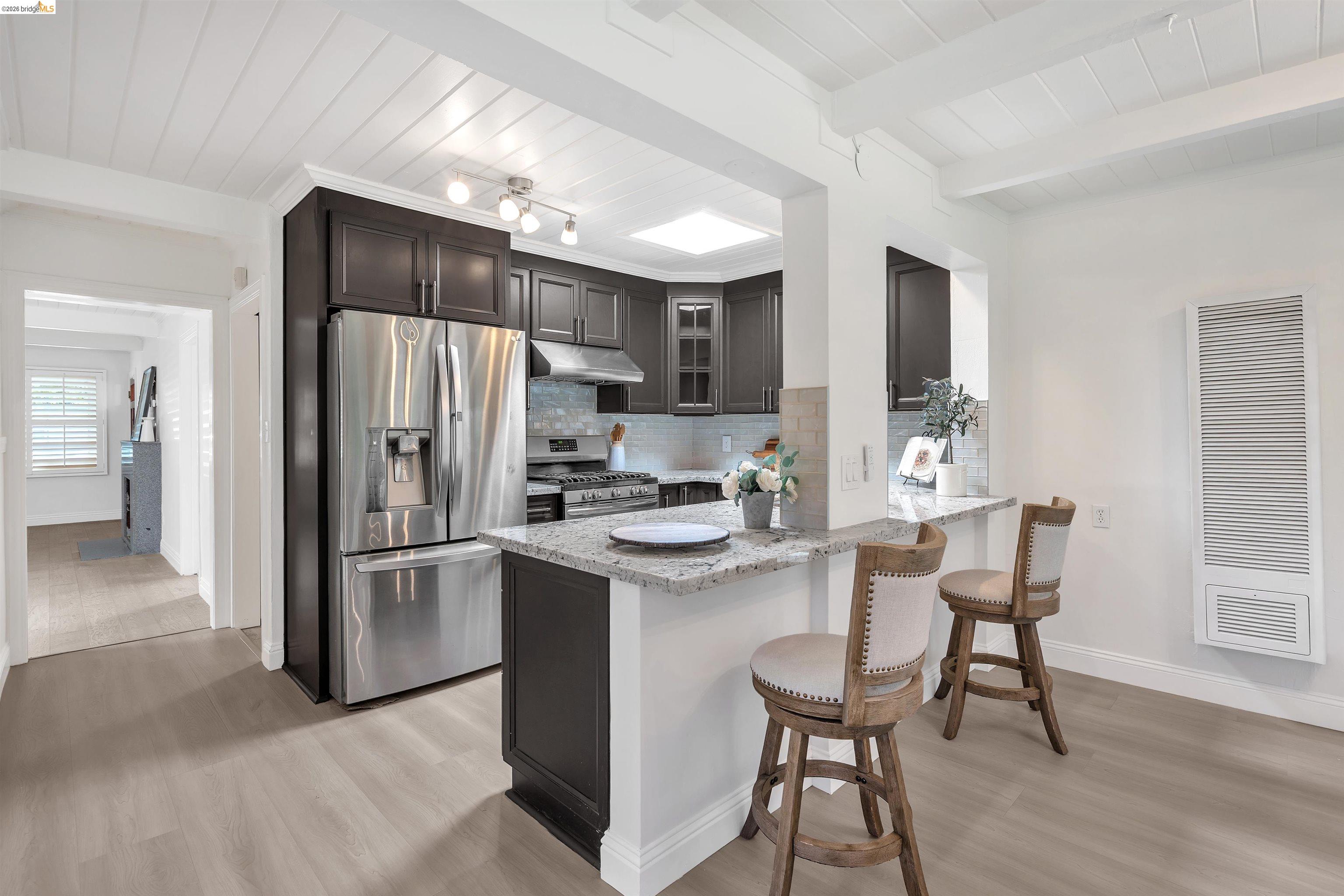 4352 Gem Avenue Castro Valley, CA 94546 - Photo 11 of 31 a kitchen with stainless steel appliances a refrigerator a stove a sink dishwasher with a dining table and chairs