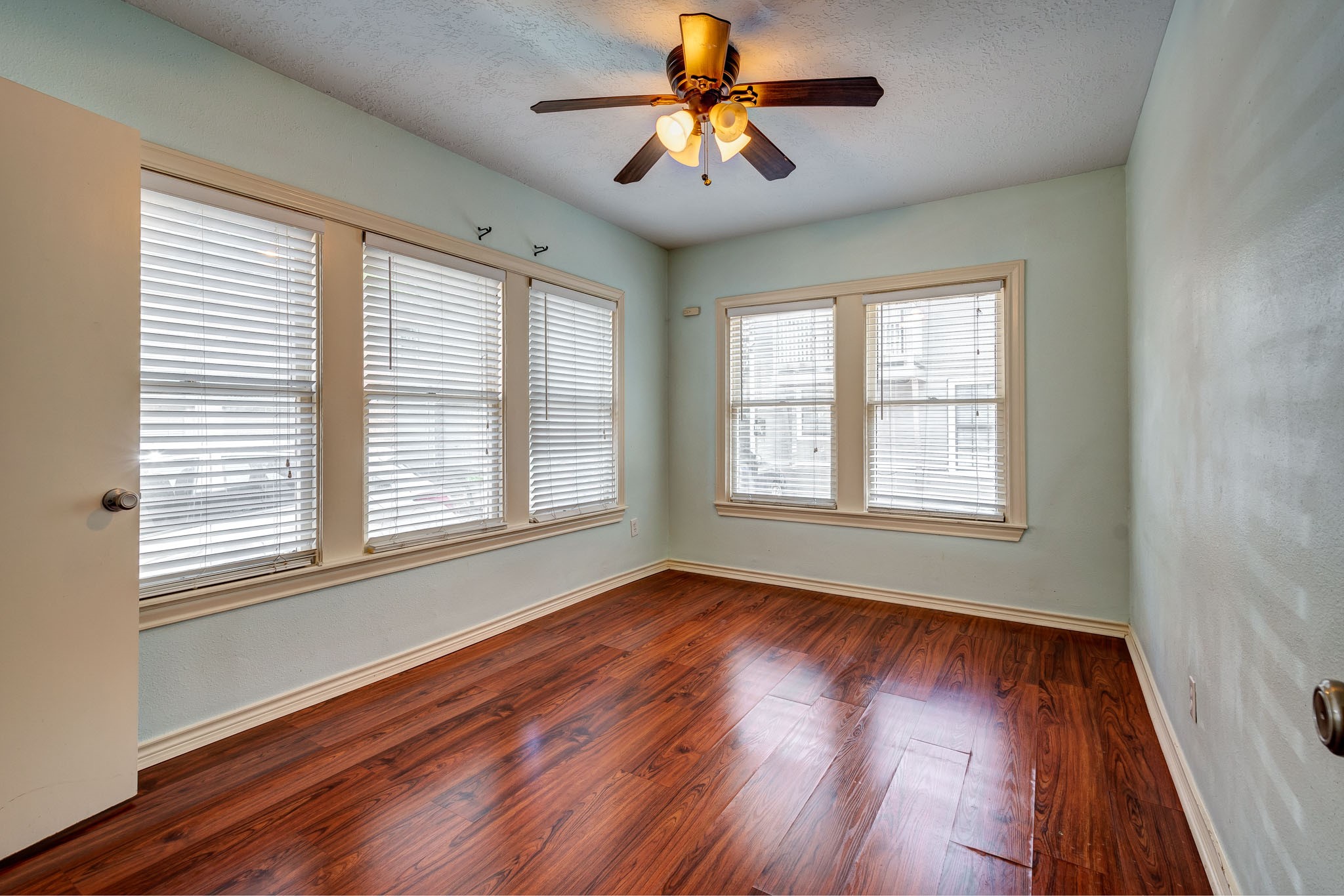 122 North Street Houston, TX 77009 - Photo 4 of 11 a view of an empty room with wooden floor and a window