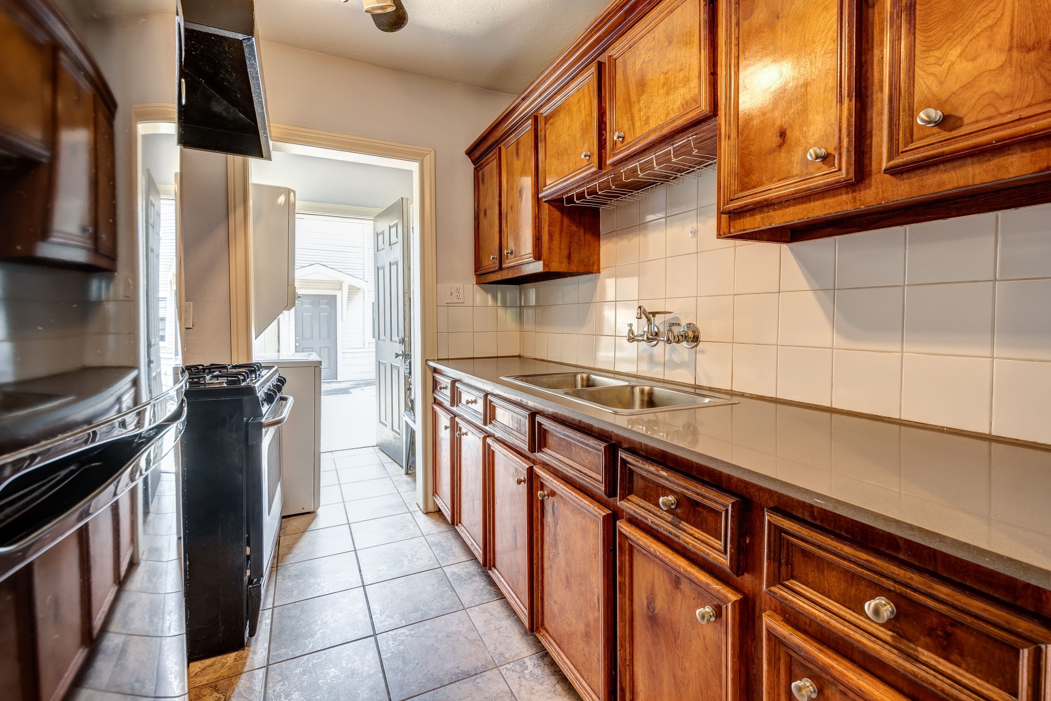 122 North Street Houston, TX 77009 - Photo 8 of 11 a kitchen with stainless steel appliances a sink stove and cabinets