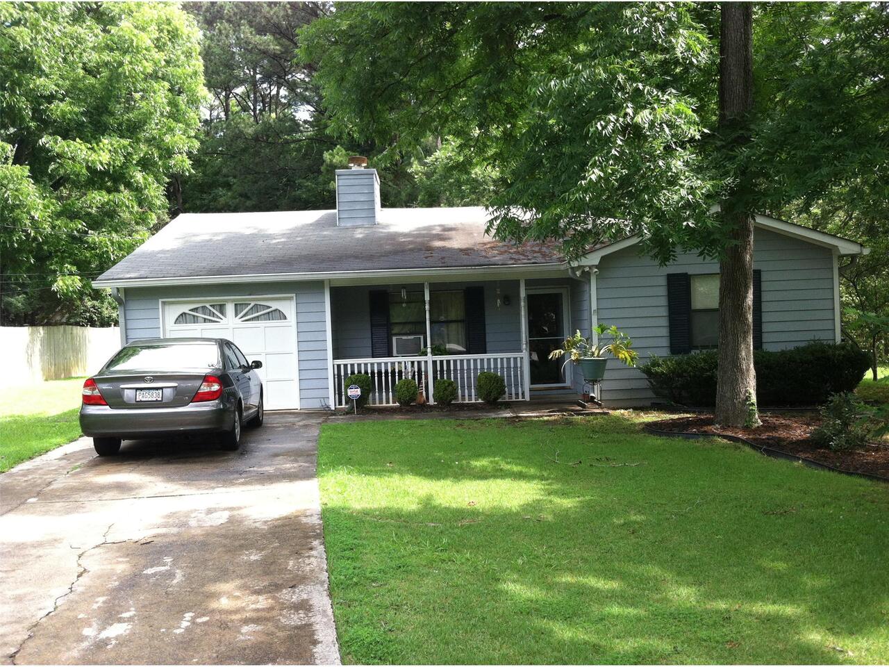 2800 John Petree Road Powder Springs, GA 30127 - Photo 1 of 1 a car parked in front of a house and a yard