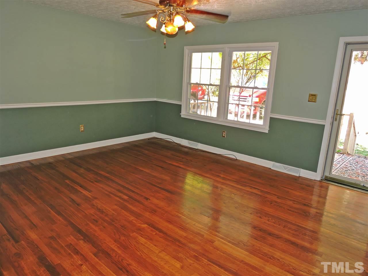 1228 Dover Street Roxboro, NC 27573 - Photo 2 of 11 a view of a room with wooden floor and fan