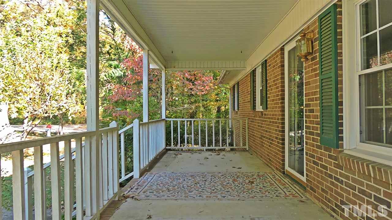1228 Dover Street Roxboro, NC 27573 - Photo 11 of 11 a view of a porch with wooden floor and roof