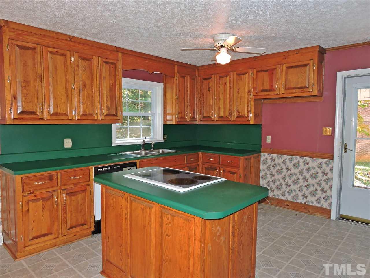 1228 Dover Street Roxboro, NC 27573 - Photo 5 of 11 a kitchen that has a sink and chair