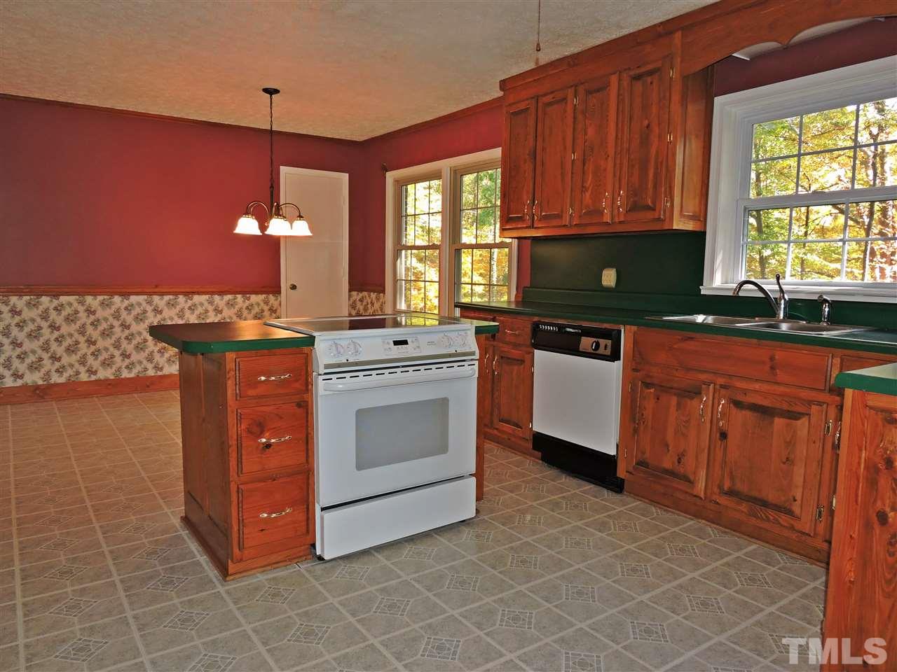 1228 Dover Street Roxboro, NC 27573 - Photo 6 of 11 a kitchen with stainless steel appliances granite countertop a stove a sink and a microwave