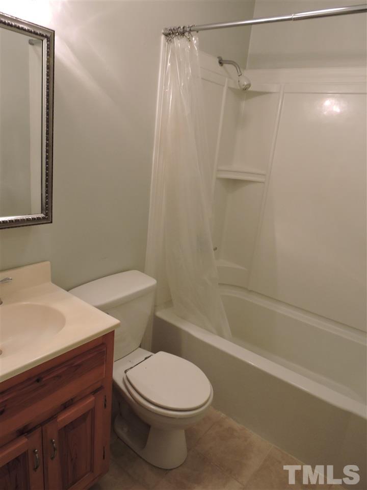 1228 Dover Street Roxboro, NC 27573 - Photo 8 of 11 a white toilet sitting next to a bath tub