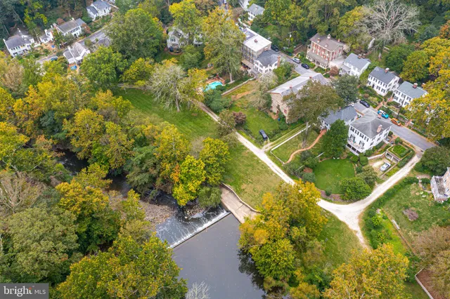 an aerial view of a house with a yard and lake view