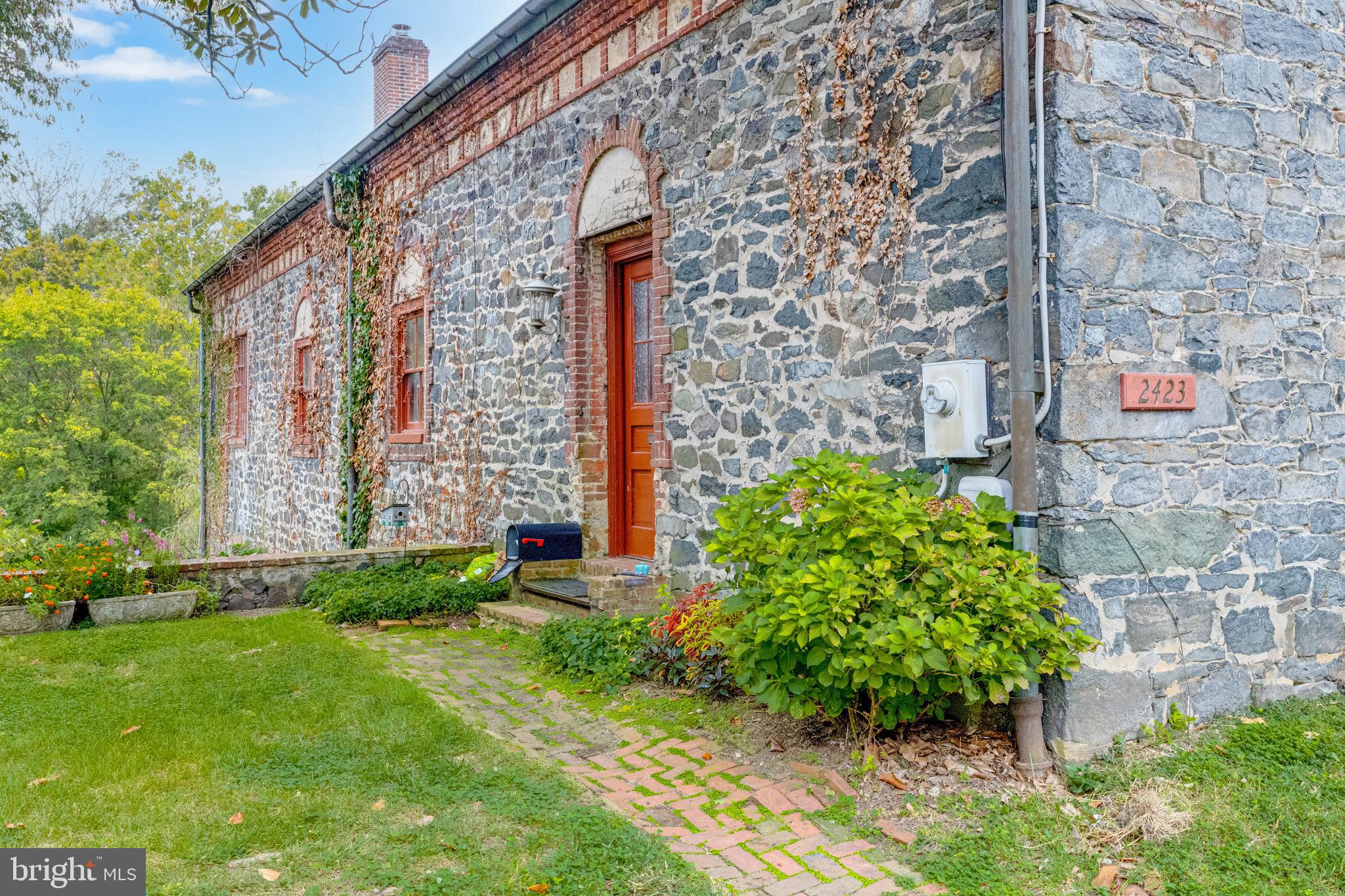 2423 Pickwick Road Baltimore, MD 21207 - Photo 2 of 34 a front view of a house with a yard