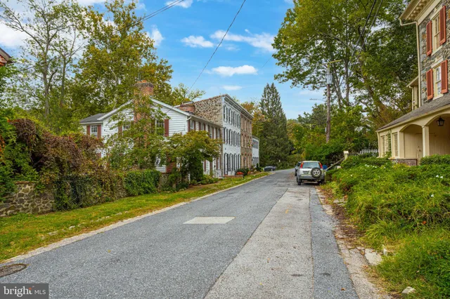 a view of house with outdoor space and parking