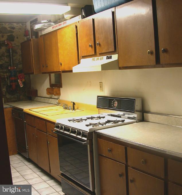 2423 Pickwick Road Baltimore, MD 21207 - Photo 27 of 34 a kitchen with stainless steel appliances granite countertop a sink stove and cabinets
