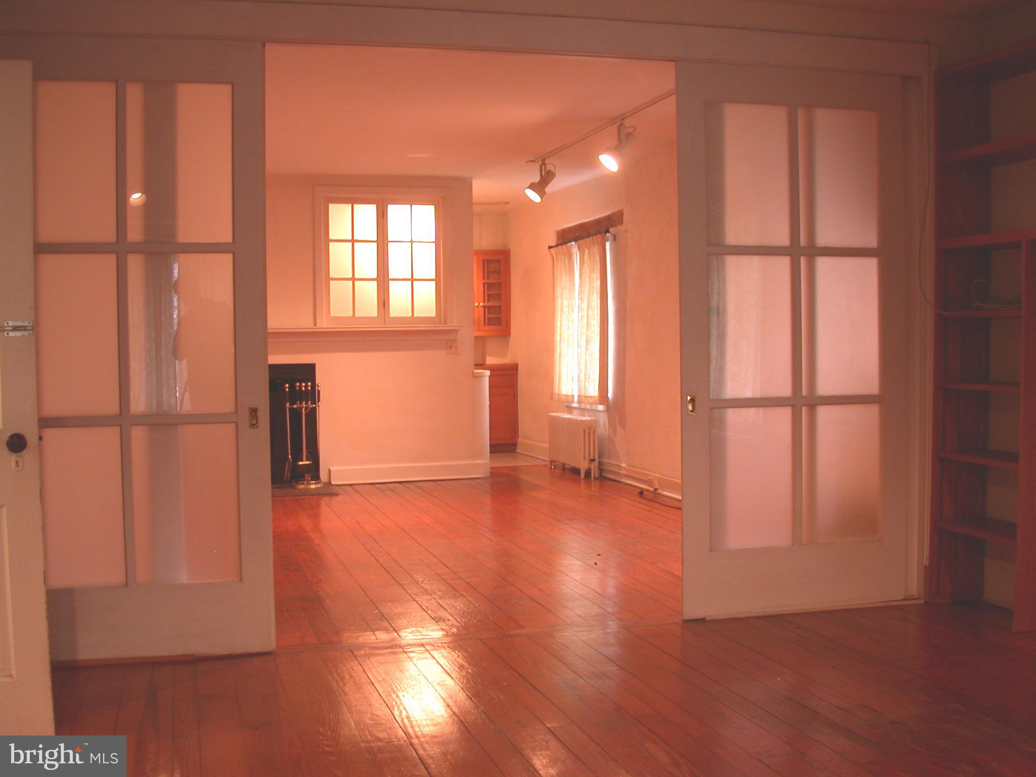 2423 Pickwick Road Baltimore, MD 21207 - Photo 32 of 34 an empty room with wooden floor and windows