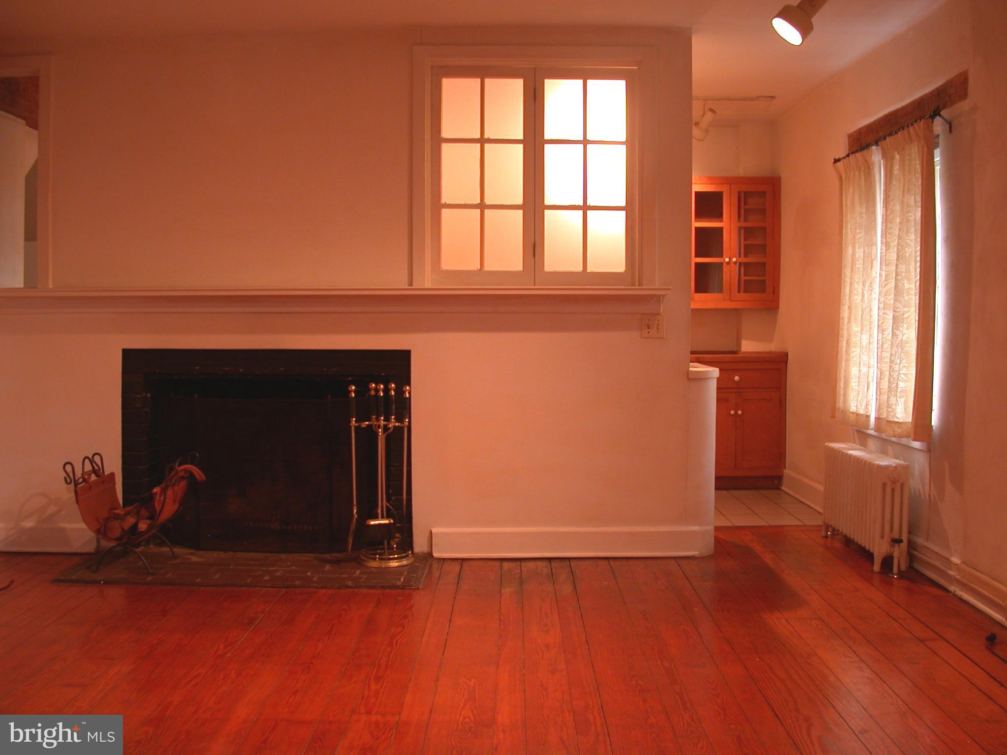 2423 Pickwick Road Baltimore, MD 21207 - Photo 34 of 34 an empty room with wooden floor and windows