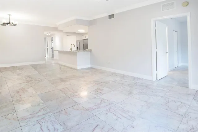 a view of a kitchen with a sink and white cabinets
