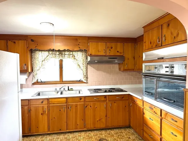 a kitchen with stainless steel appliances granite countertop a sink and a stove