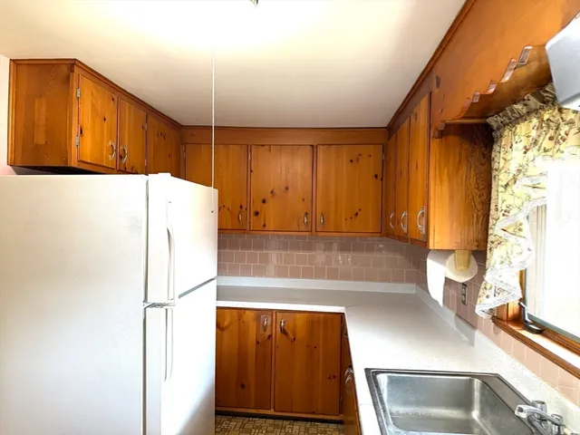 a kitchen with a refrigerator and a sink
