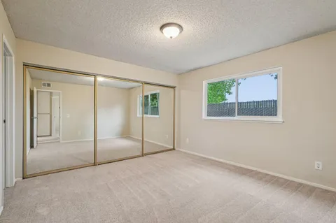 an empty room with windows and closet