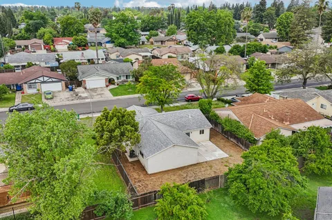 an aerial view of a house with a yard and lake view