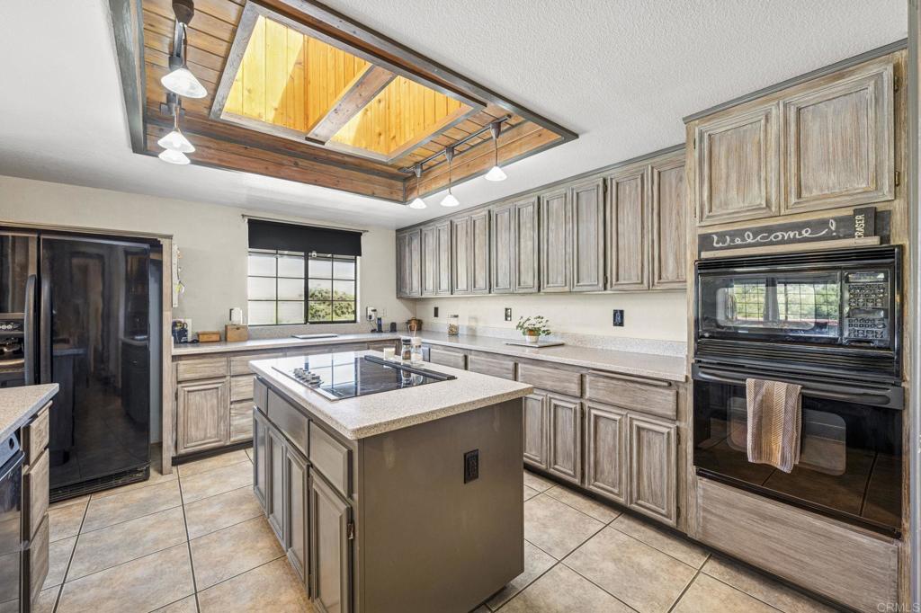 3223 Olive Hill Road Fallbrook, CA 92028 - Photo 13 of 64 a kitchen with stainless steel appliances granite countertop a stove sink and cabinets