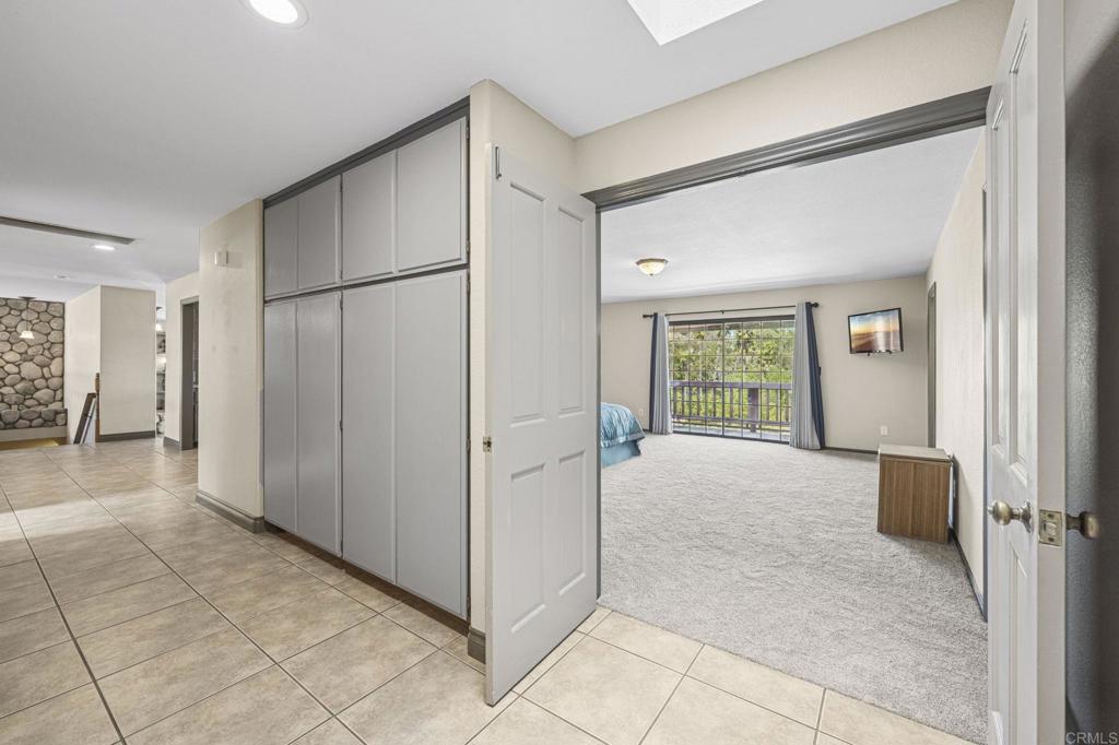 3223 Olive Hill Road Fallbrook, CA 92028 - Photo 19 of 64 a view of a big room with windows and refrigerator