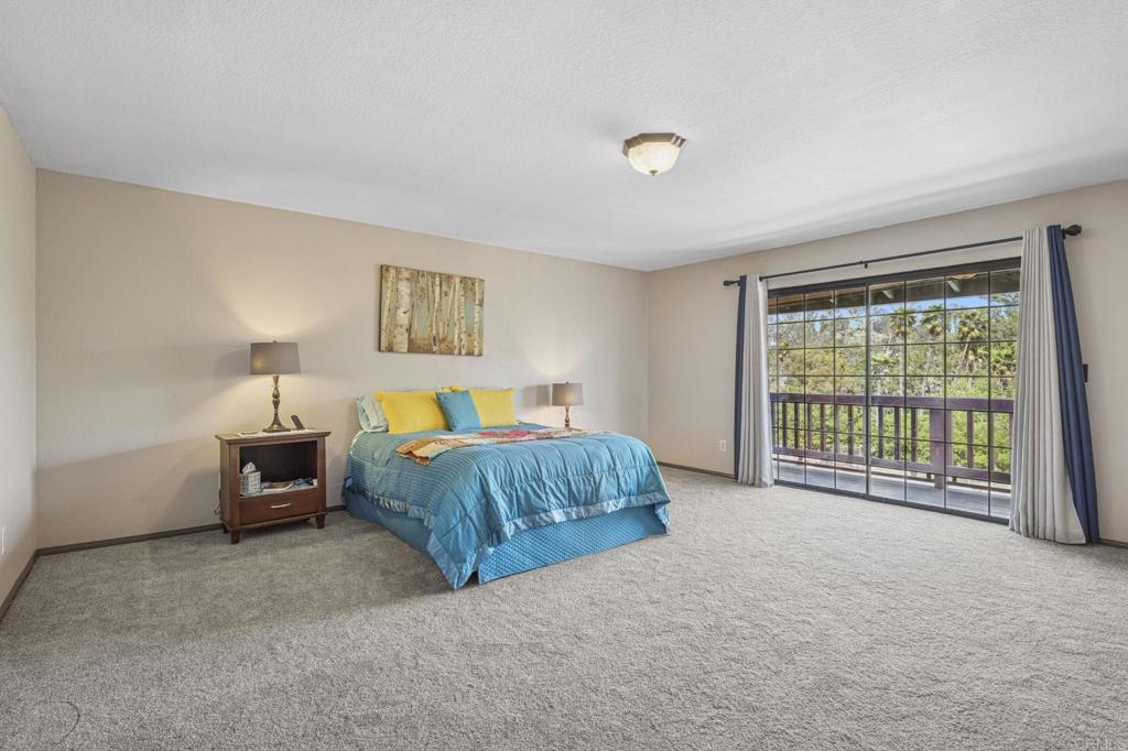 3223 Olive Hill Road Fallbrook, CA 92028 - Photo 20 of 64 a bedroom with a bed and a night stand