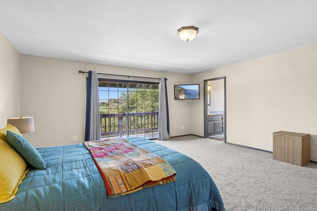 3223 Olive Hill Road Fallbrook, CA 92028 - Photo 21 of 64 a bed sitting in a bedroom next to a window