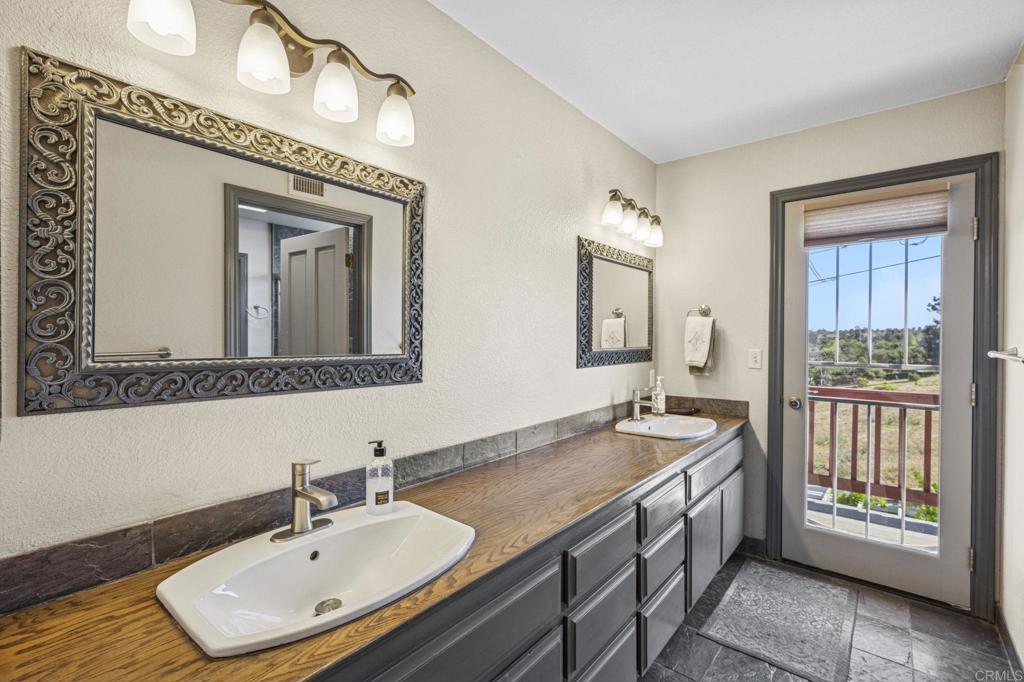 3223 Olive Hill Road Fallbrook, CA 92028 - Photo 23 of 64 a bathroom with a sink and a mirror