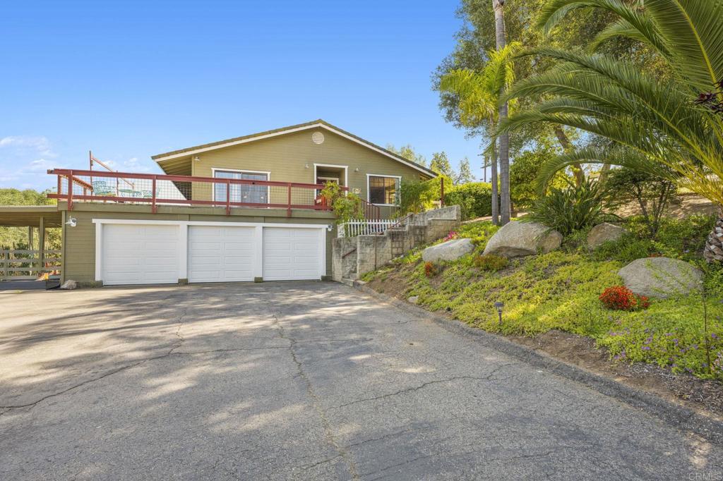 3223 Olive Hill Road Fallbrook, CA 92028 - Photo 54 of 64 a front view of a house with a yard and garage