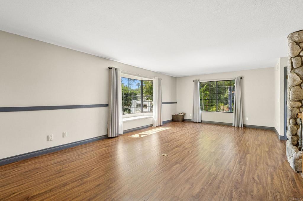 3223 Olive Hill Road Fallbrook, CA 92028 - Photo 60 of 64 an empty room with wooden floor and windows