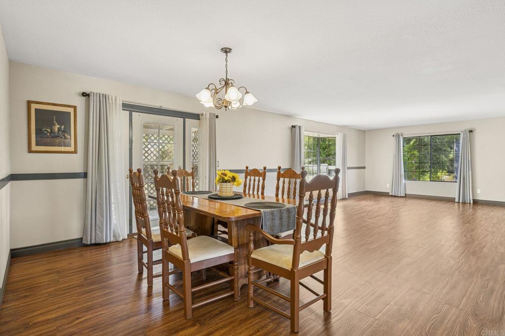 3223 Olive Hill Road Fallbrook, CA 92028 - Photo 61 of 64 a view of a dining room with furniture wooden floor and chandelier
