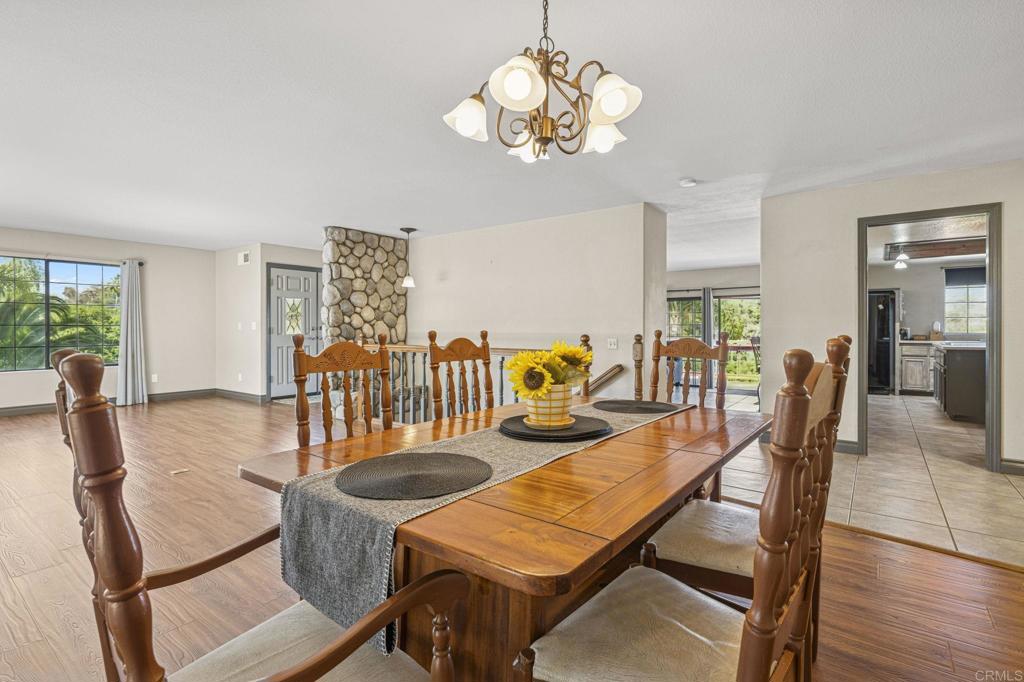 3223 Olive Hill Road Fallbrook, CA 92028 - Photo 62 of 64 a view of a dining room with furniture a chandelier and wooden floor